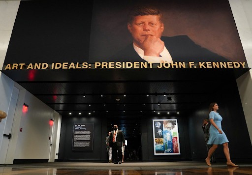 Interior of the Kennedy Center with a large portrait of President John F. Kennedy beneath the exhibit title Art and Ideals: President John F. Kennedy