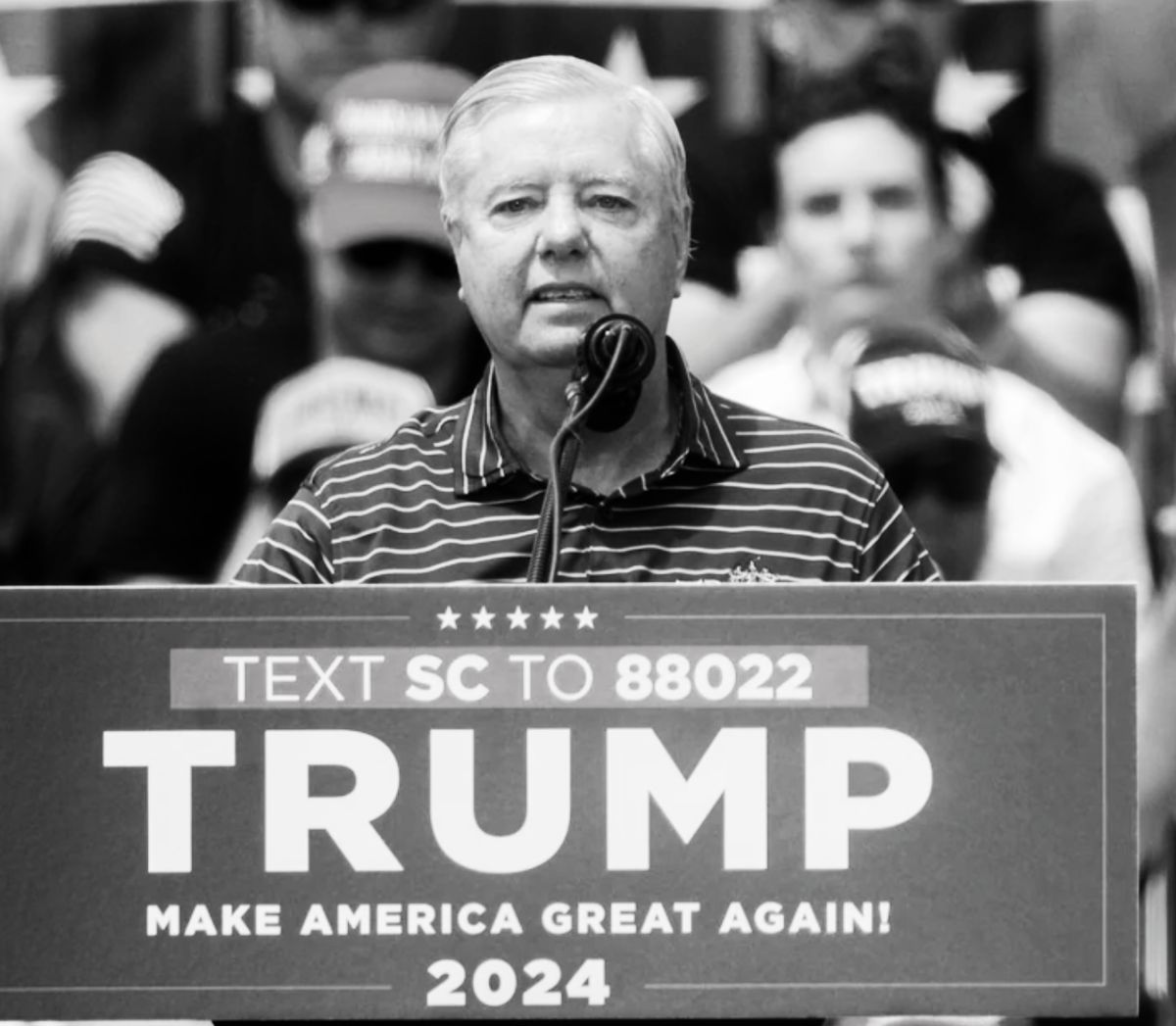 Black and white photo of a sad Lindsey Graham on stage